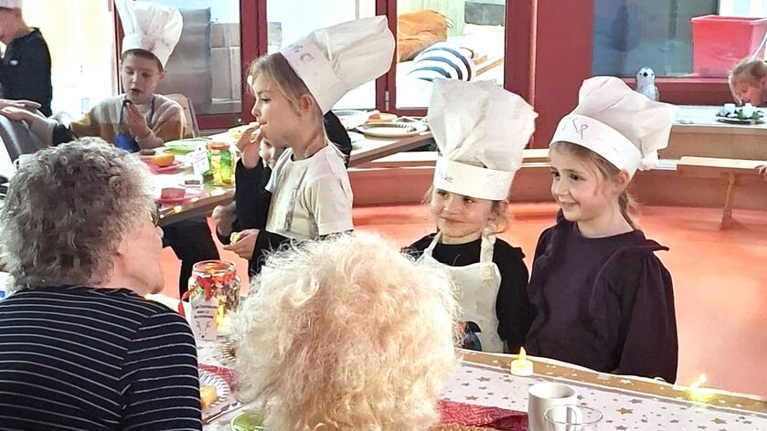 Kleuters van obs Prinses Beatrix voorzien de ouderen van hapjes.