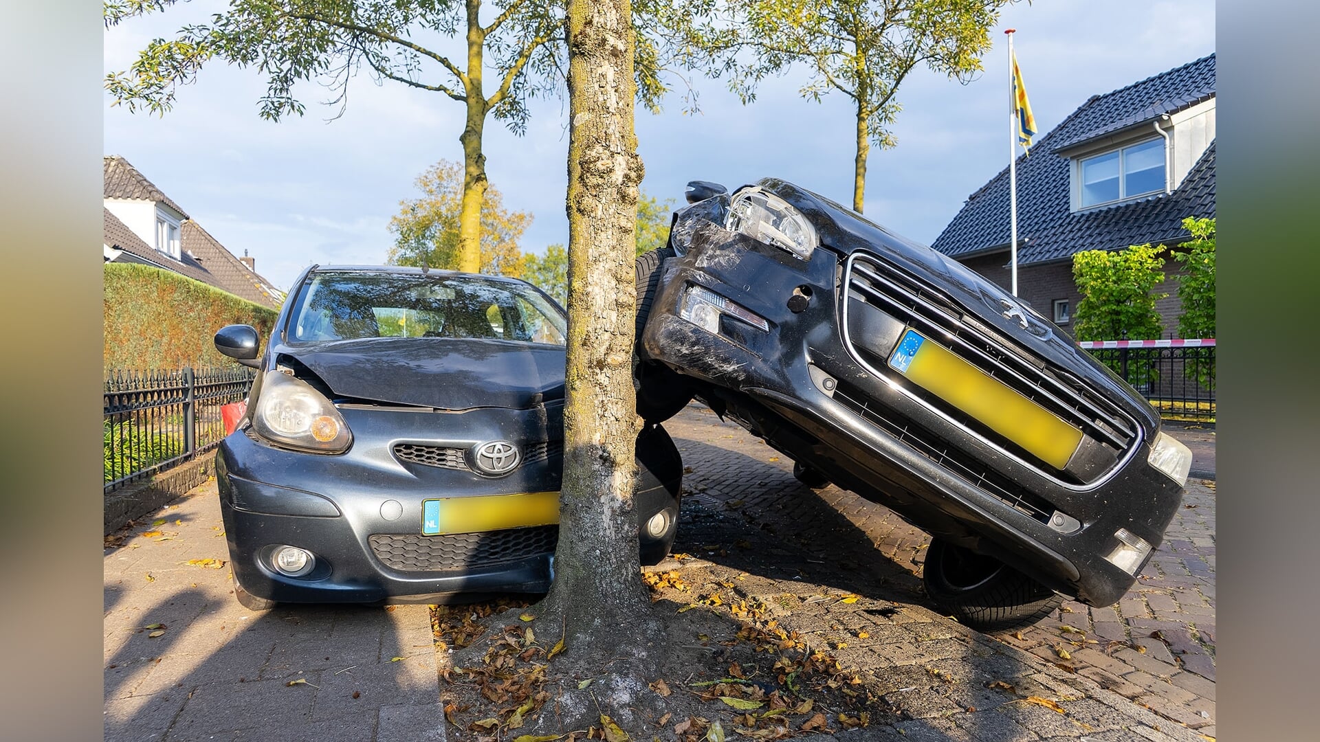 Auto moet uitwijken en belandt bovenop geparkeerde auto
